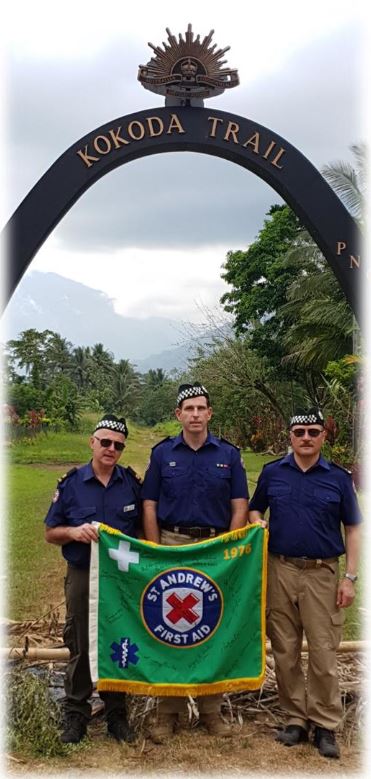 St Andrews staff standing under the Kokoda Trail arch